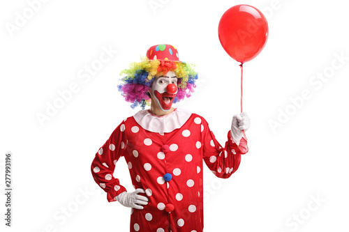 Cheerful clown holding a red balloon