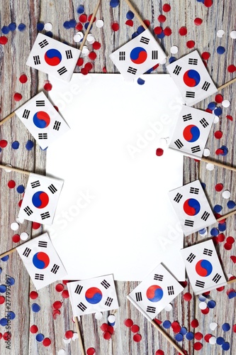 happy independence day South Korea. 15 Aug. the concept of freedom, independence and patriotism. flags and confetti with sheets of white paper on a wooden background. vertical