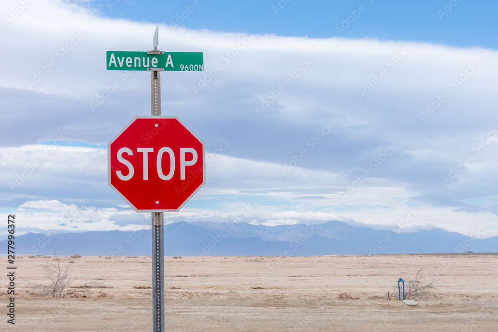 American red Stop road sign on a desert highway