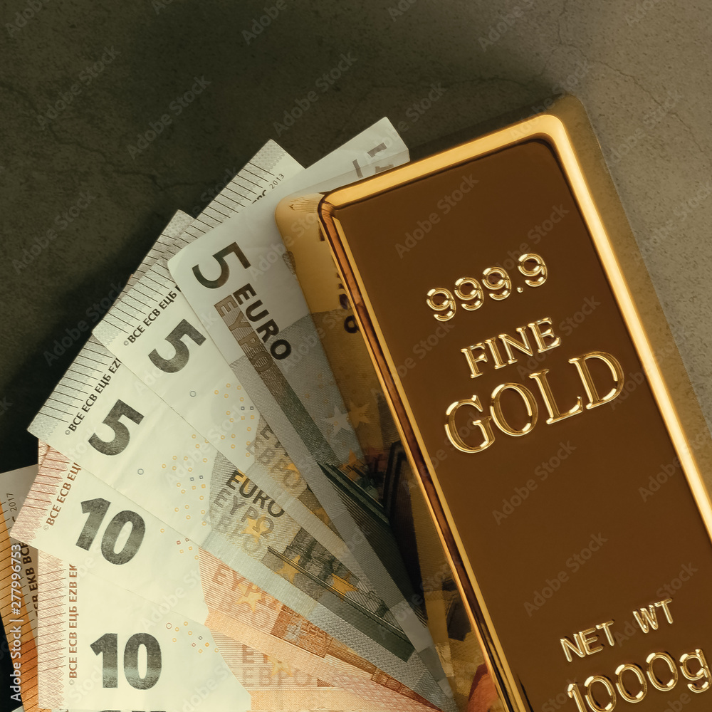 Gold metal ingot in ingots on the background of Euro banknotes. Gold metal ingot in ingots on the background of Euro banknotes.