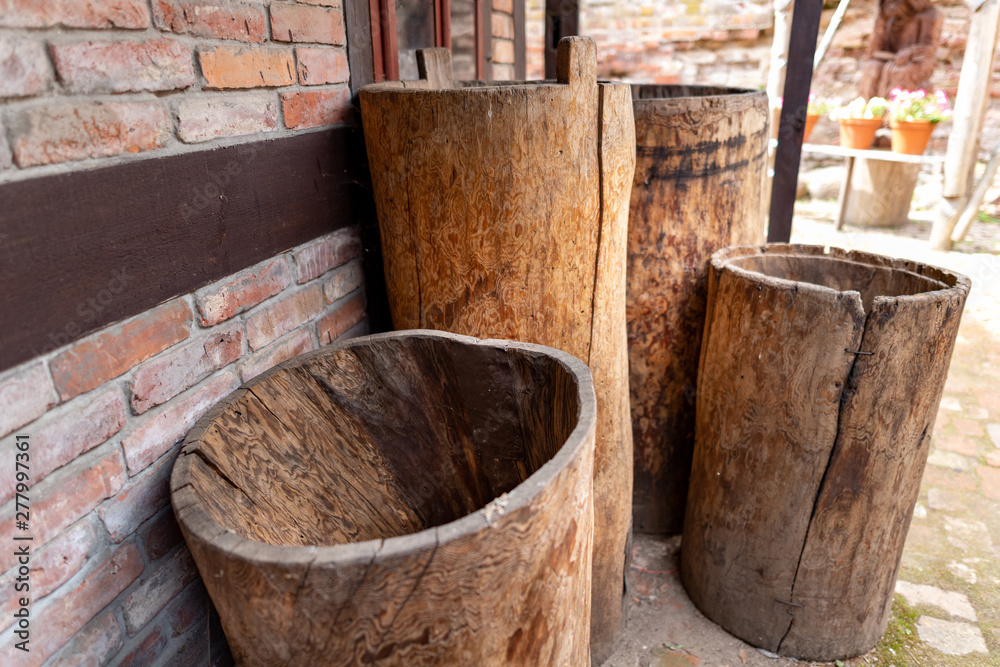 Water containers made of wood. Old barrels carved from the trunk of a tree.