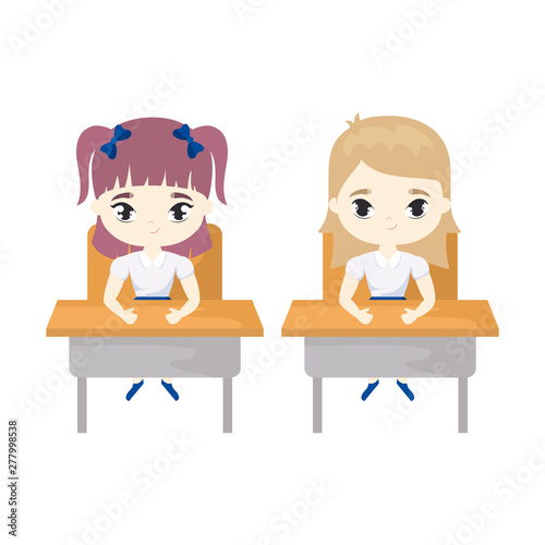 little student girls seated in school desks