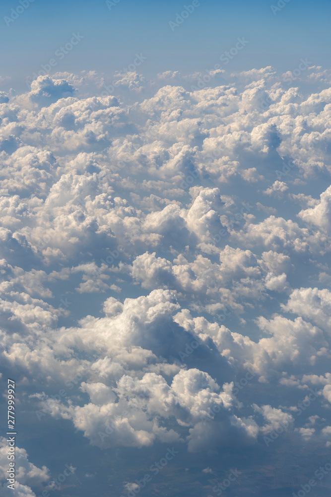 White clouds and blue sky, a view from airplane window