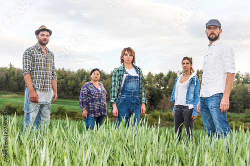 Group of rural people standing at countryside while looking camera
