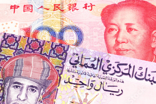 Wallpaper Mural A multicolored one rial note from Oman, close up in macro with a red, Chinese one hundred yuan renminbi bill Torontodigital.ca
