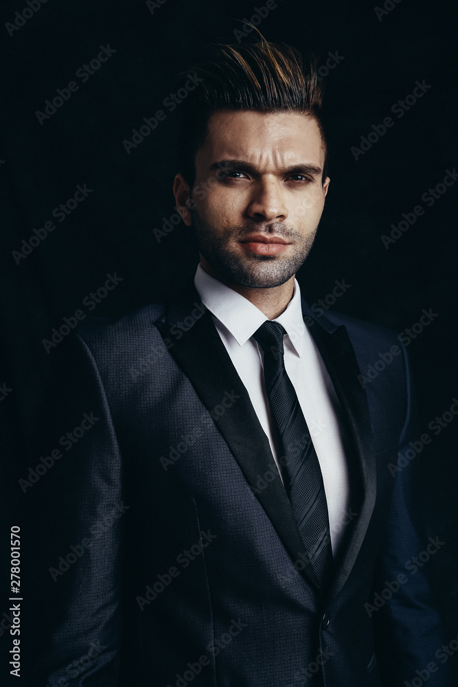 Portrait of a young man. Male studio portrait with cinema light and dark backdrop. Portrait of a young man. Male studio portrait with cinema light and dark backdrop.