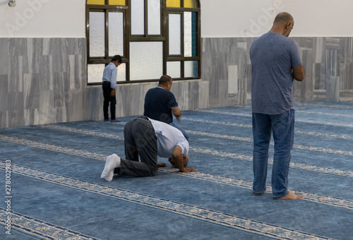Muslim believers pray in prayer room of the Ahmadiyya Shaykh Mahmud mosque in Haifa city in Israel