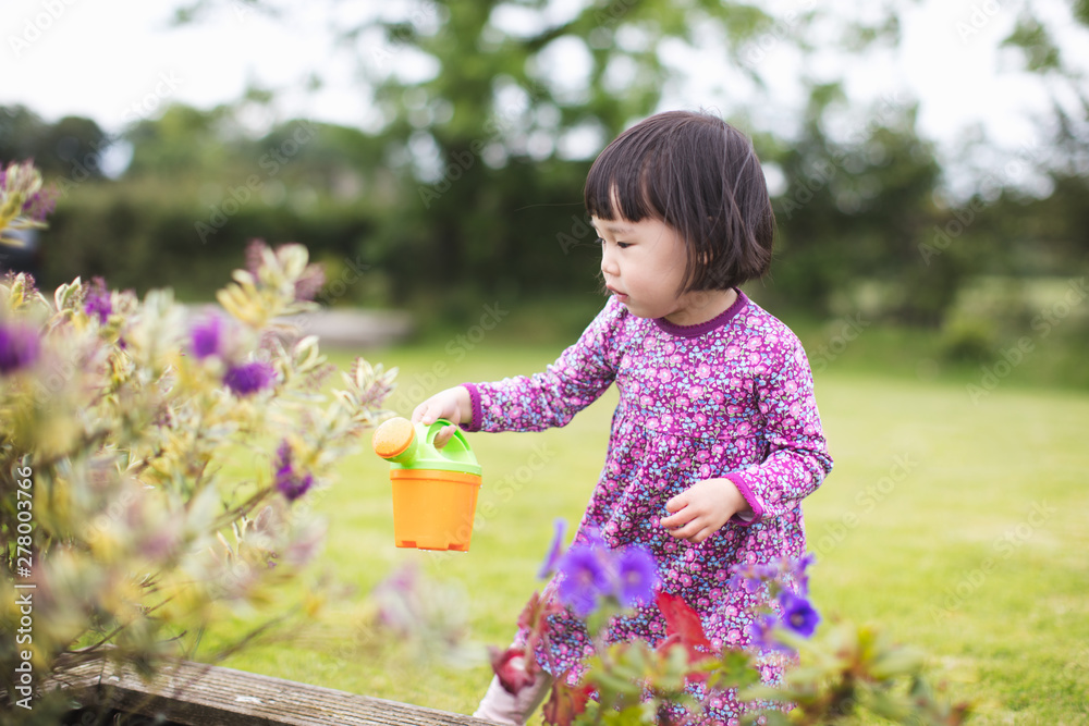 toddler girl prepend playing gardening at countryside home garden toddler girl prepend playing gardening at countryside home garden