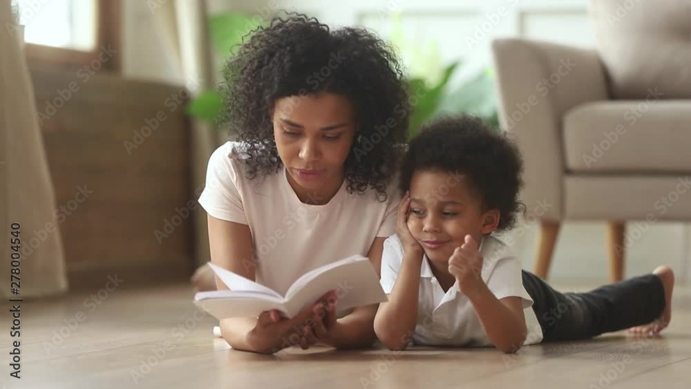 Loving african mother reading book to smart cute kid son Loving african mother reading book to smart cute kid son