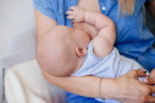 Mum is breastfeeding a child.