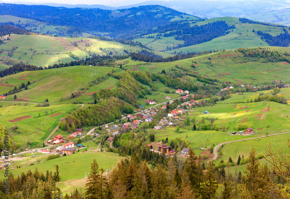 Beautiful landscape of the Carpathian Mountains, Ukraine, overlooking the village from the top of the mountain.