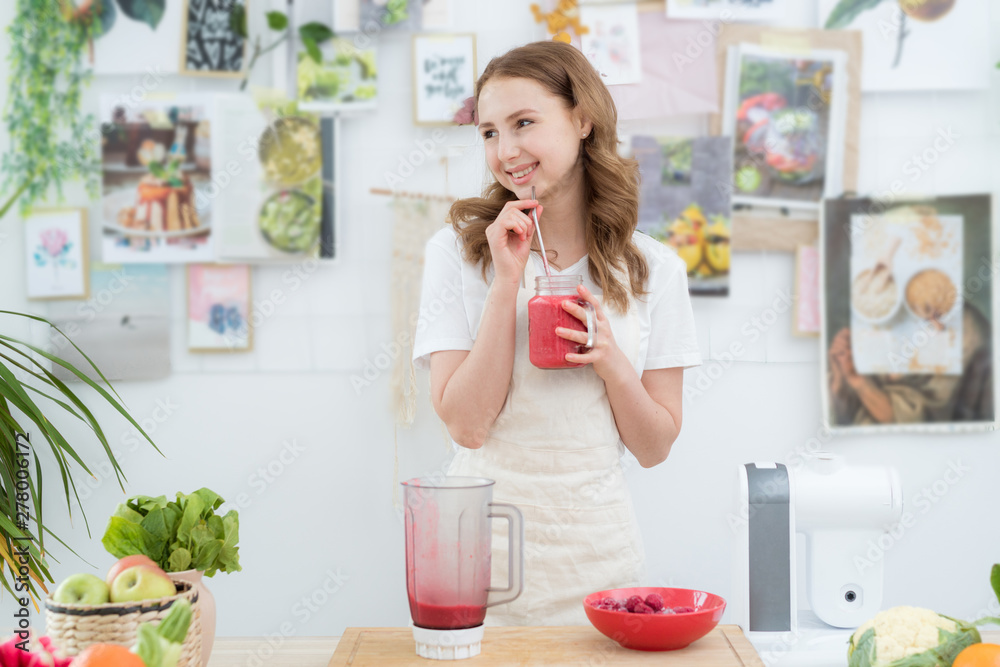 A beautiful girl drinks a freshly made smoothie from berries. The concept of a healthy diet, healthy lifestyle. A beautiful girl drinks a freshly made smoothie from berries. The concept of a healthy diet, healthy lifestyle.