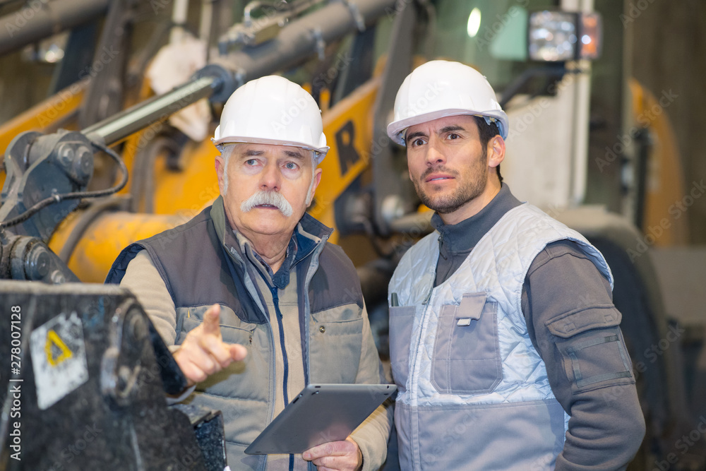 heavy equipment mechanics observing something heavy equipment mechanics observing something
