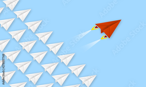 Red plane made of paper metaphor for rev up to business success with blue background photo