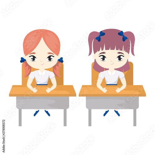 little student girls seated in school desks