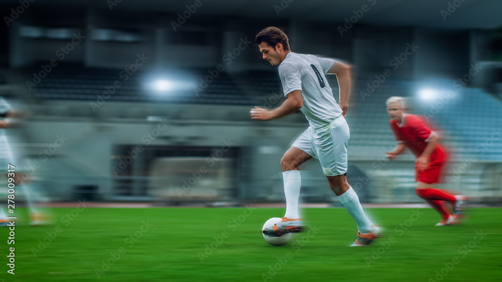 Blurred Motion Shot of Professional Soccer Player Leads with a Ball. Two Professional Football Teams Playing On a Stadium.