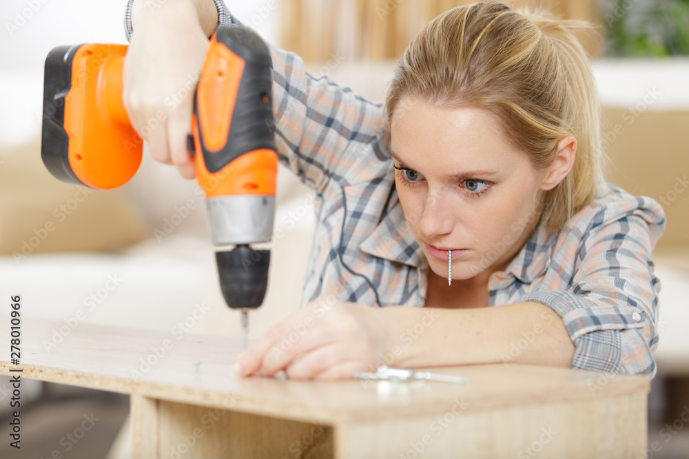 young woman worker in the carpenter workroom