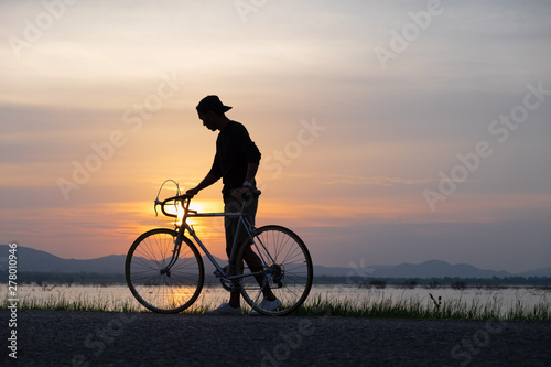 Cyclist on background of sunset, sport and travel concept © max_play