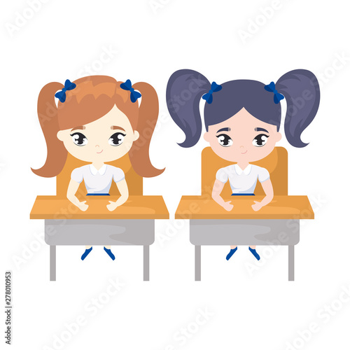 little student girls seated in school desks