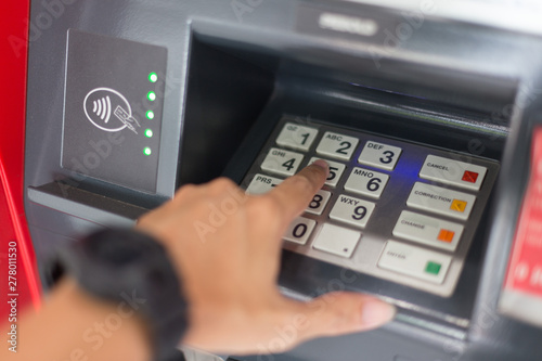 Selective focus of Hand and Keyboard on ATM photo