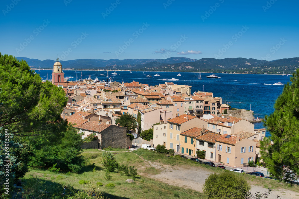 Panorama of Saint-Tropez, the roofs of houses, the chapel of St. Anne, the yacht in the bay. Commune in southeastern France in the region of Provence, Alpes - Cote d'Azur, France