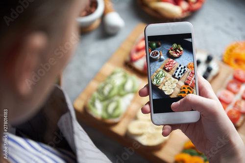 Woman capture fresh healthy food with smart phone