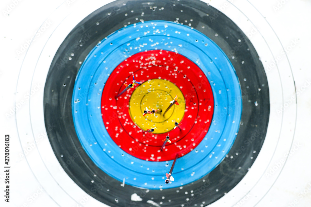 Selective focus on bottom of arrows on archery colorful target Selective focus on bottom of arrows on archery colorful target