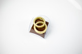 Stuffed chocolate candy decorated with chocolate rings topped with golden edible ink.