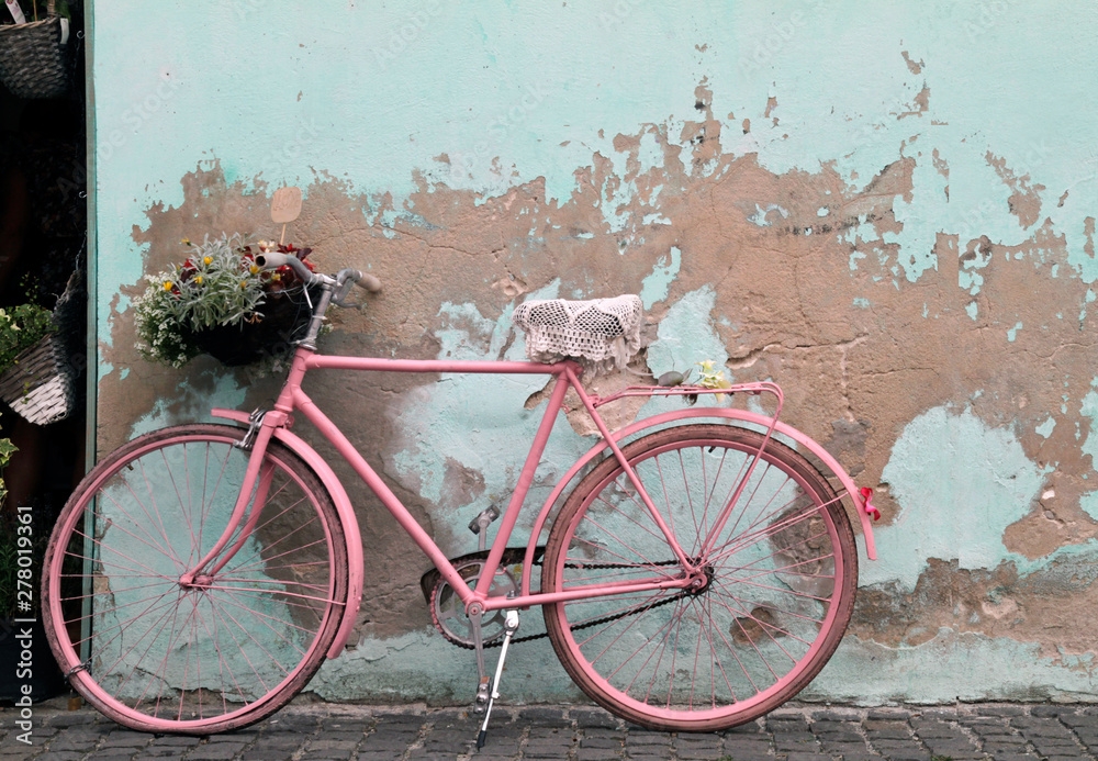 Vintage pink bicycle leaning against a wall in Havana, Cuba