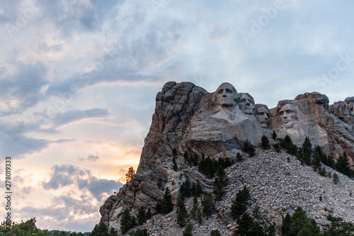 A dramatically colorful sky developing around sunset behind the four US presidents of Mount Rushmore, in North Dakota.