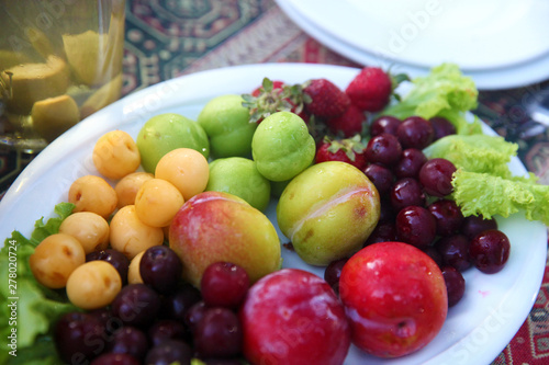 Summer fruits in plate on the table