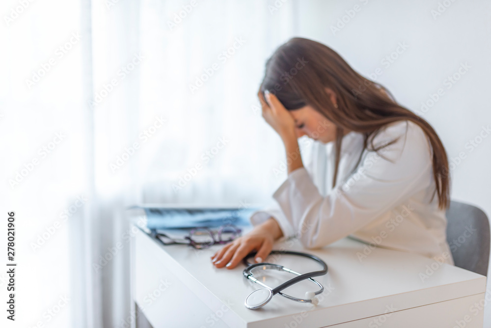 Emotion with young doctor being exhausted. Sad, stressed, upset and unhappy doctor cover face in hospital office. Depression, burnout stress and pressure from too much work Emotion with young doctor being exhausted. Sad, stressed, upset and unhappy doctor cover face in hospital office. Depression, burnout stress and pressure from too much work