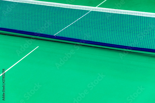 Net of tennis court on green wall background © ponsulak