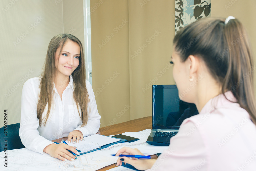 Discussion of the project in the office. Architects with drawings in the office planning work. Girls in the office. Discussion of the project in the office. Architects with drawings in the office planning work. Girls in the office.