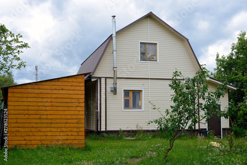 Canvas Print Typical Russian cottage, dacha in Russian.
