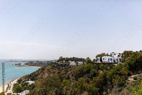 Sidi Bou Said, Tunisia - June.06, 2019: Alley with traditional white houses and blue doors.