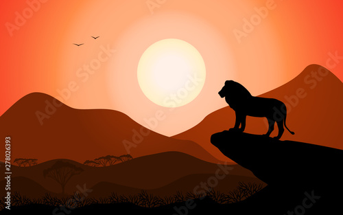 Lion king standing on a rock against a sunset