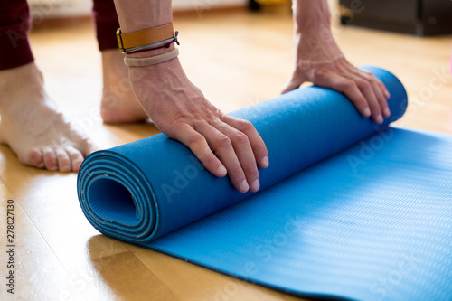 The concept of yoga and fitness mat in the hands.