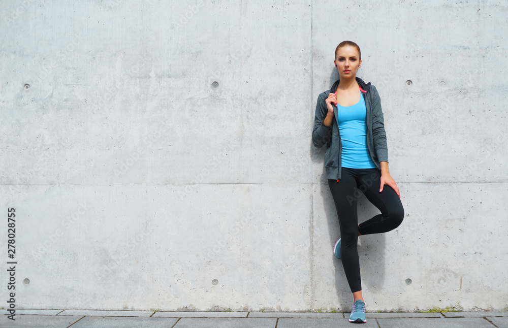 Young, fit and sporty brunette girl in sportswear. Woman doing sports outdoor. Young, fit and sporty brunette girl in sportswear. Woman doing sports outdoor.