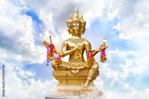 Golden of Brahma statue religious with blue sky with white spindrift very clouds background of thailand.
