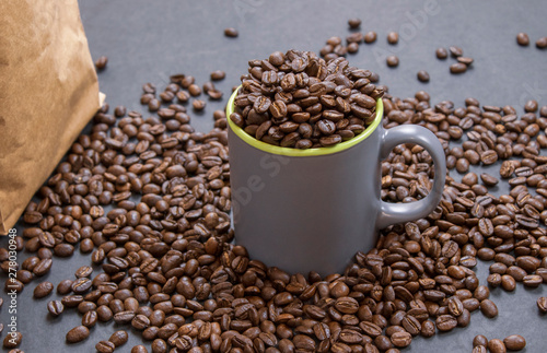 coffee beans in dark coffee cup on isolated dark textured background
