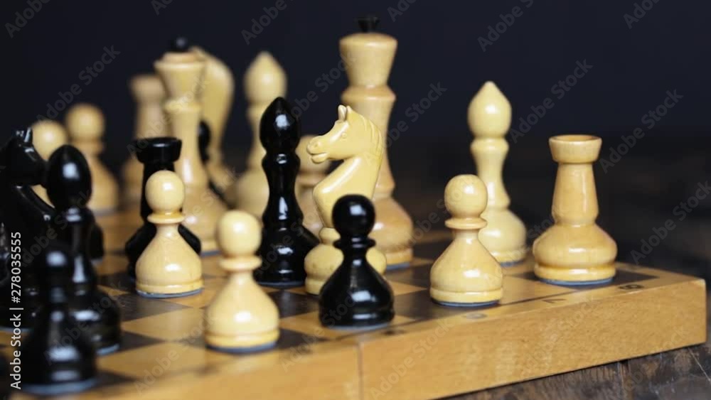 Chess pieces standing on a chessboard. Project shooting Chess pieces standing on a chessboard. Project shooting