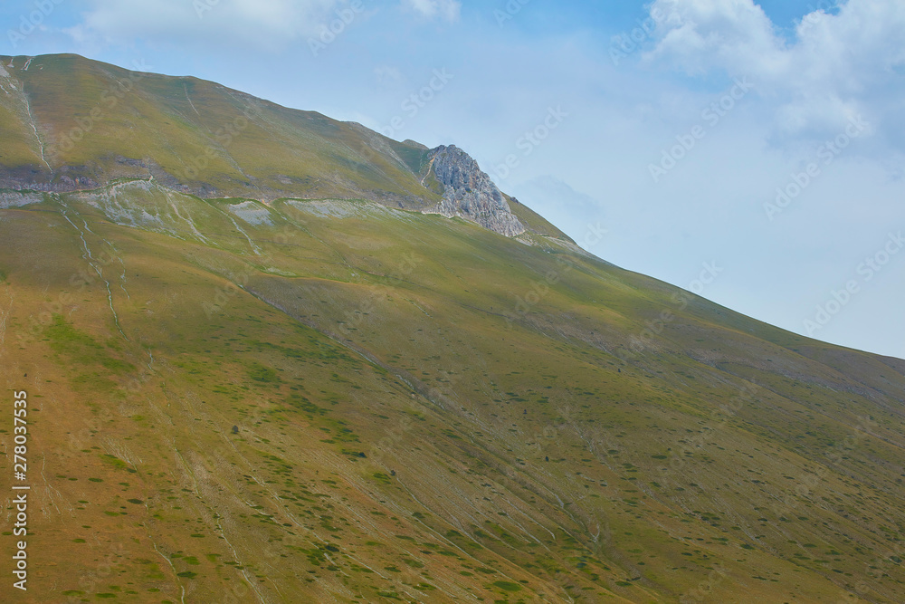 beautiful landscape of the large plain of Castelluccio di Norcia, situated in the umbria region, in the park of the Sibillini mountains, the crops in bloom create a suggestion of colors and shapes.