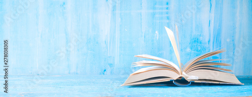 open book, close up on blue grungy background,reading, education, literature,learning, good copy space