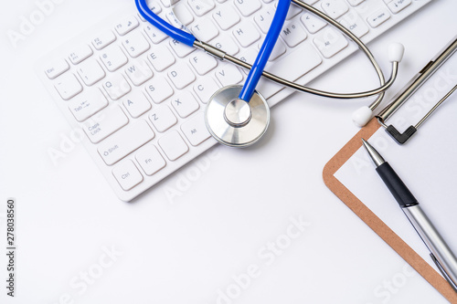Medical Concept - Stethoscope on computer keyboard on white background. Physician long term care treatment concept. Top view, flat lay, copy space