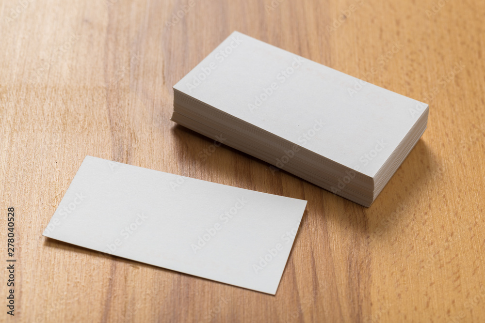 Mockup of business cards stack at wooden background. Design concept. Template for branding identity. Mockup of business cards stack at wooden background. Design concept. Template for branding identity.