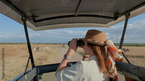 Woman on a safari trip in Masai Mara park, Kenya