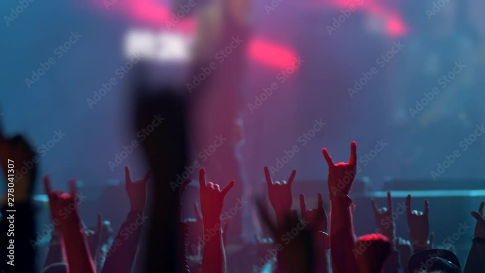 Crowd raising up their hands applauding the musicians on great concert summer musical festival