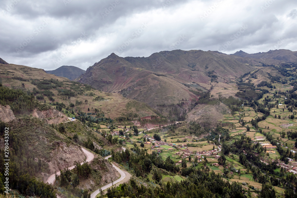 View of Pisac Archaeological Park and green mountains of the Sacred Valley of the Incas, Peru