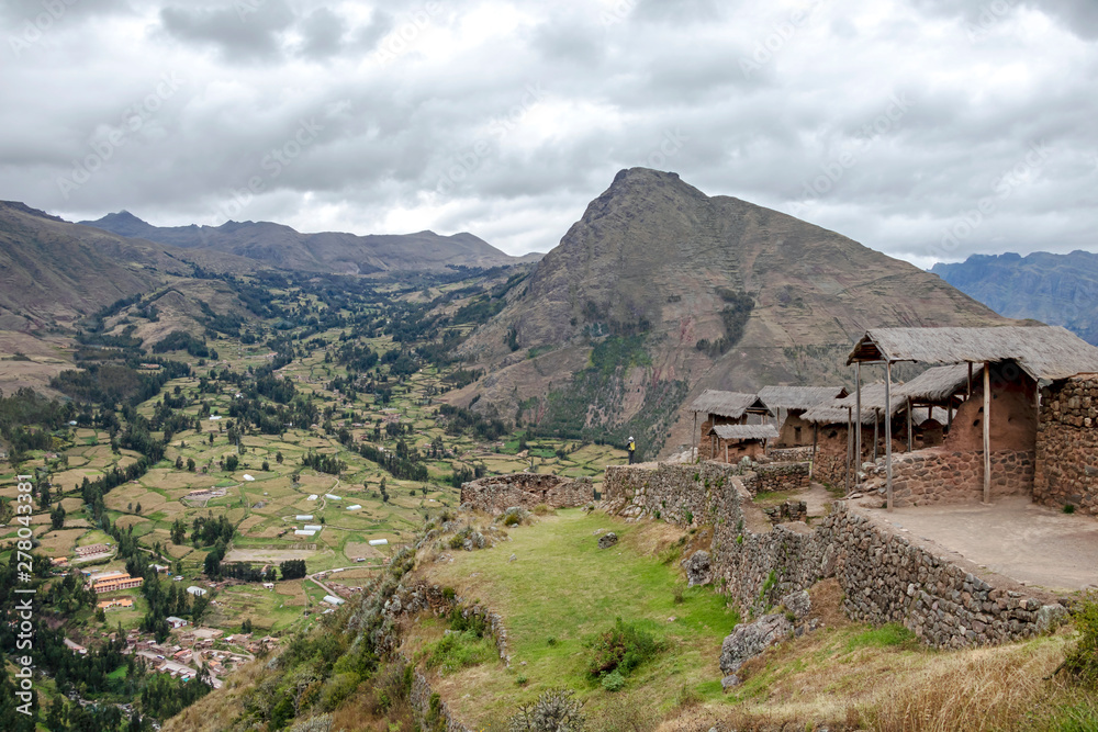Inca ruins in Pisac archeological site and green peruvian Andes mountains, Sacred valley of the Incas, Peru